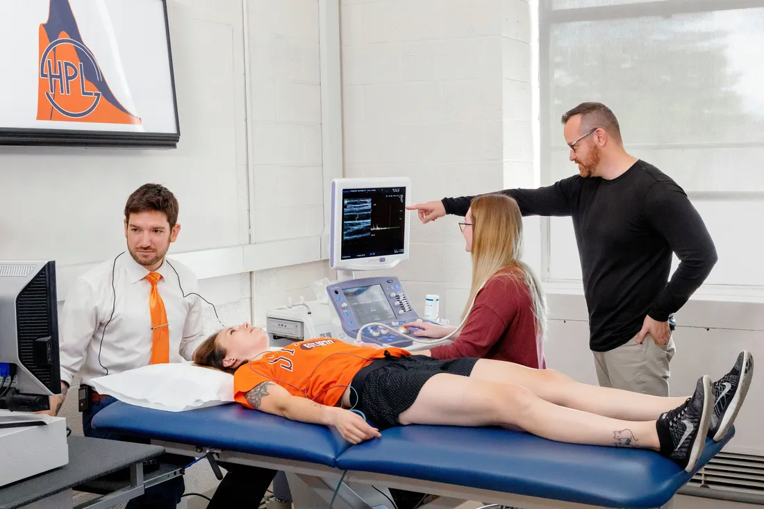 Students and faculty working on the exercise science laboratory.